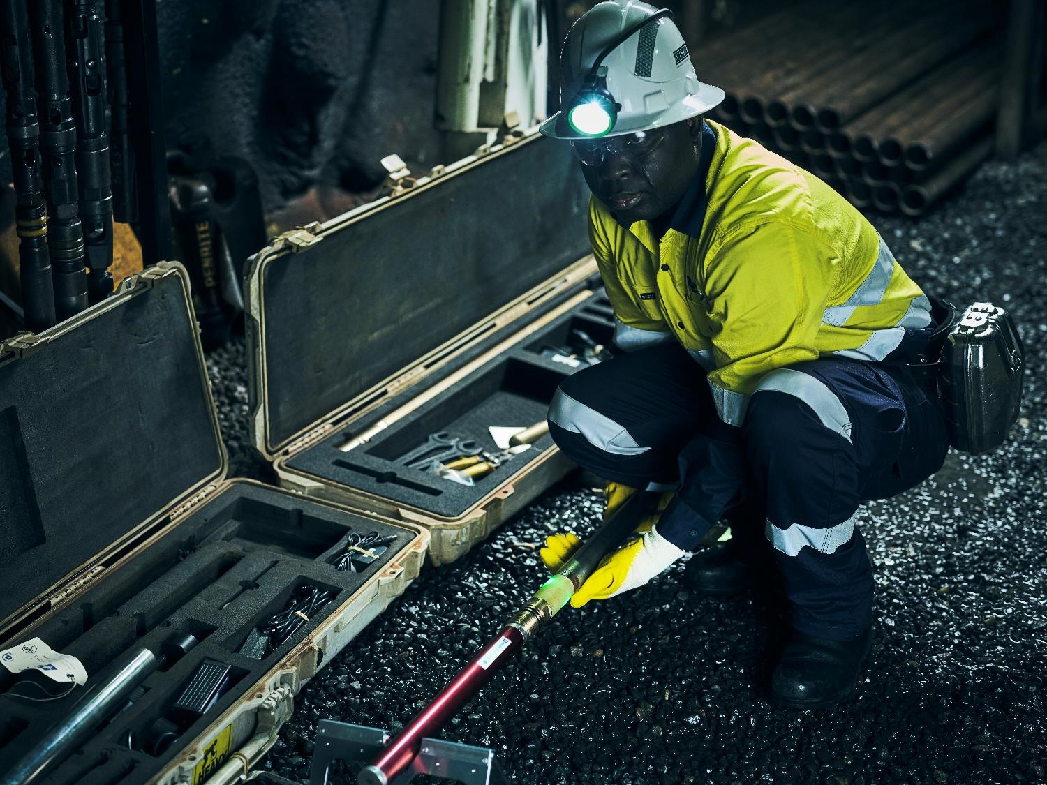 underground mine worker using IMDEX Gyros in a protective suit and helmet